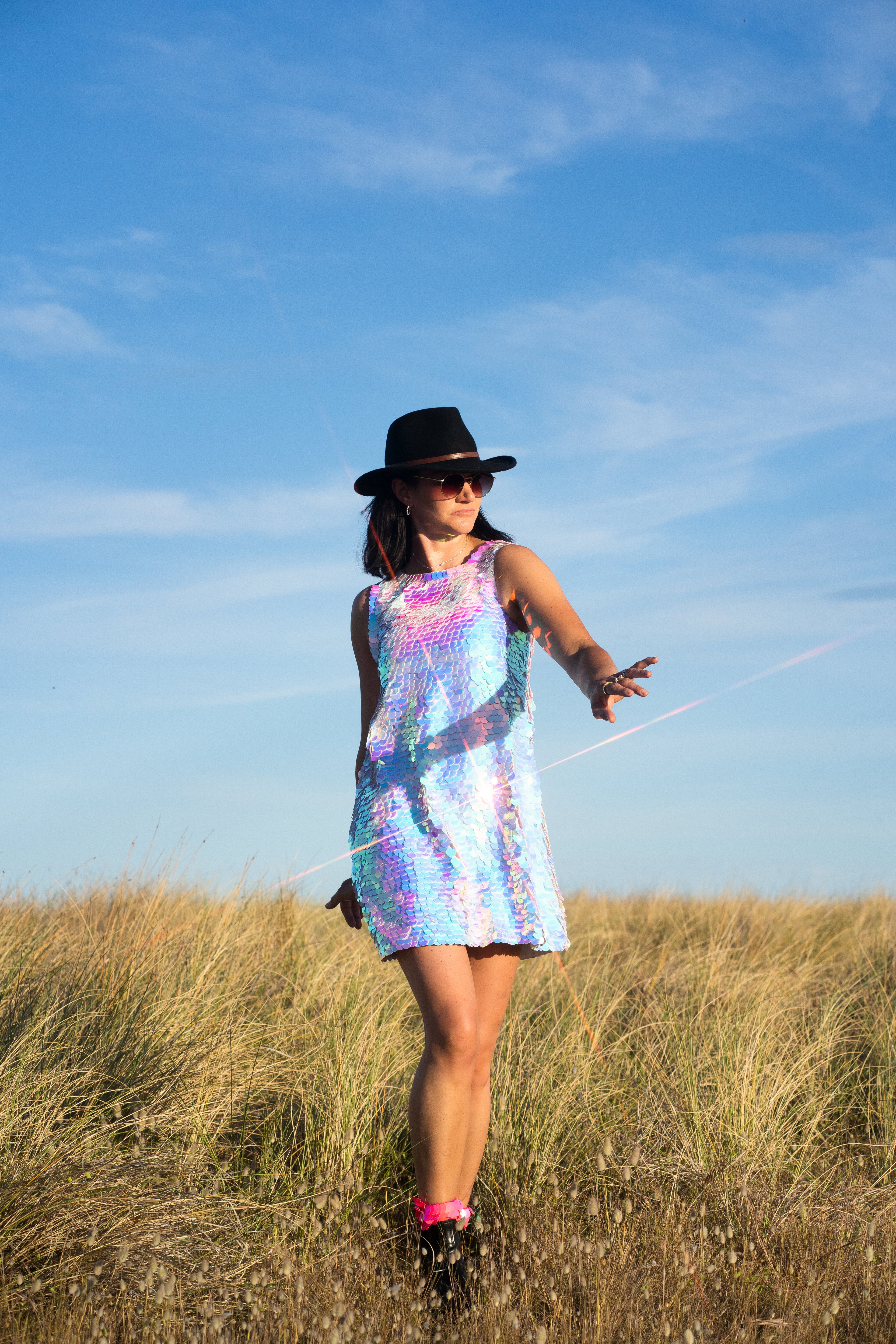 woman at festival in sequin dress shining like a disco ball 