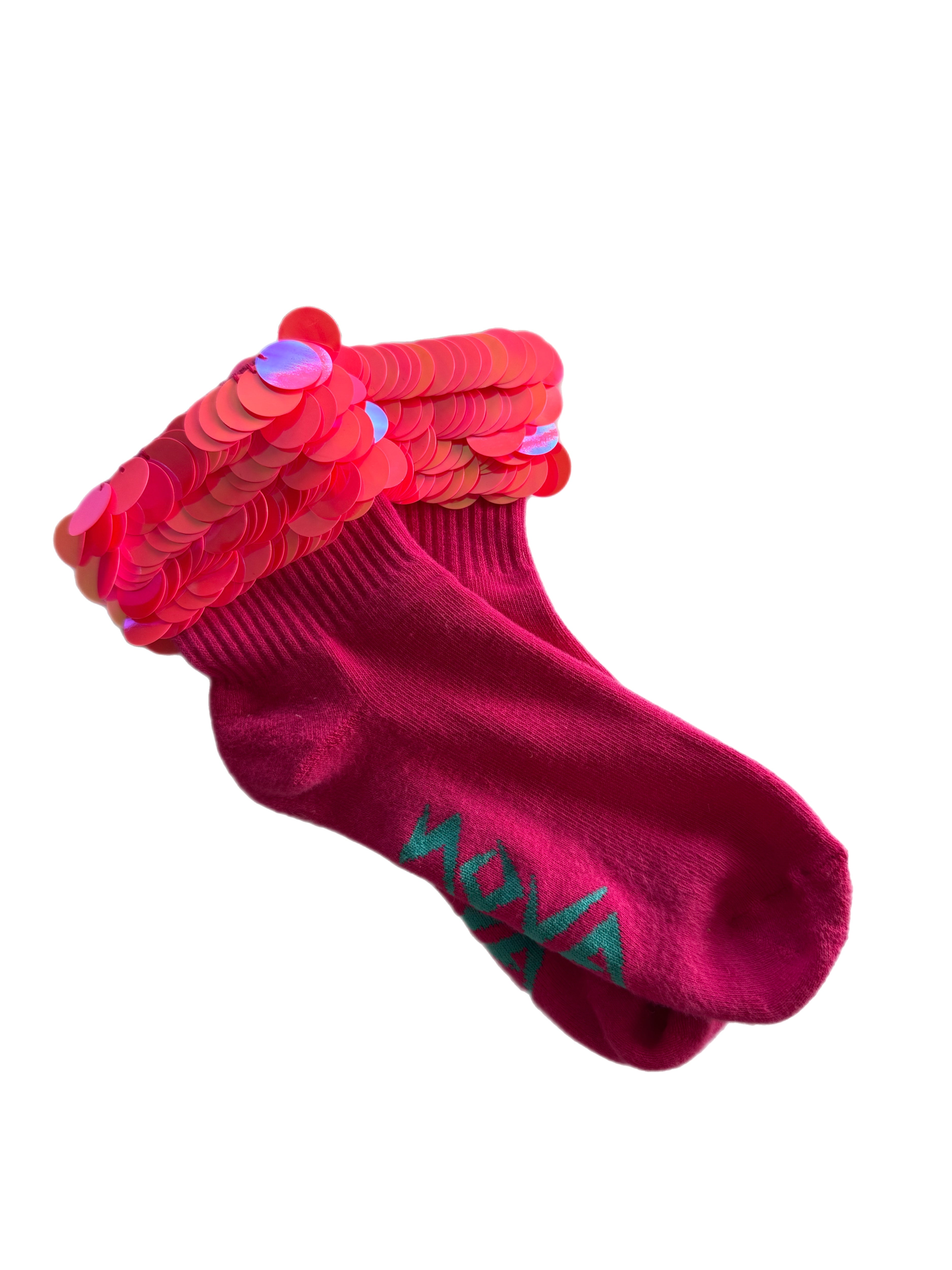 A pair of magenta pink ankle socks with a textured ribbed cuff decorated with overlapping pink and red sequins, featuring the brand name 'NOVA' embroidered in teal on the side.